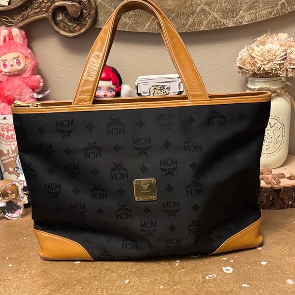 MCM Handbags - MCM Black Canvas Tote with Cognac Trim and Gold Plaque